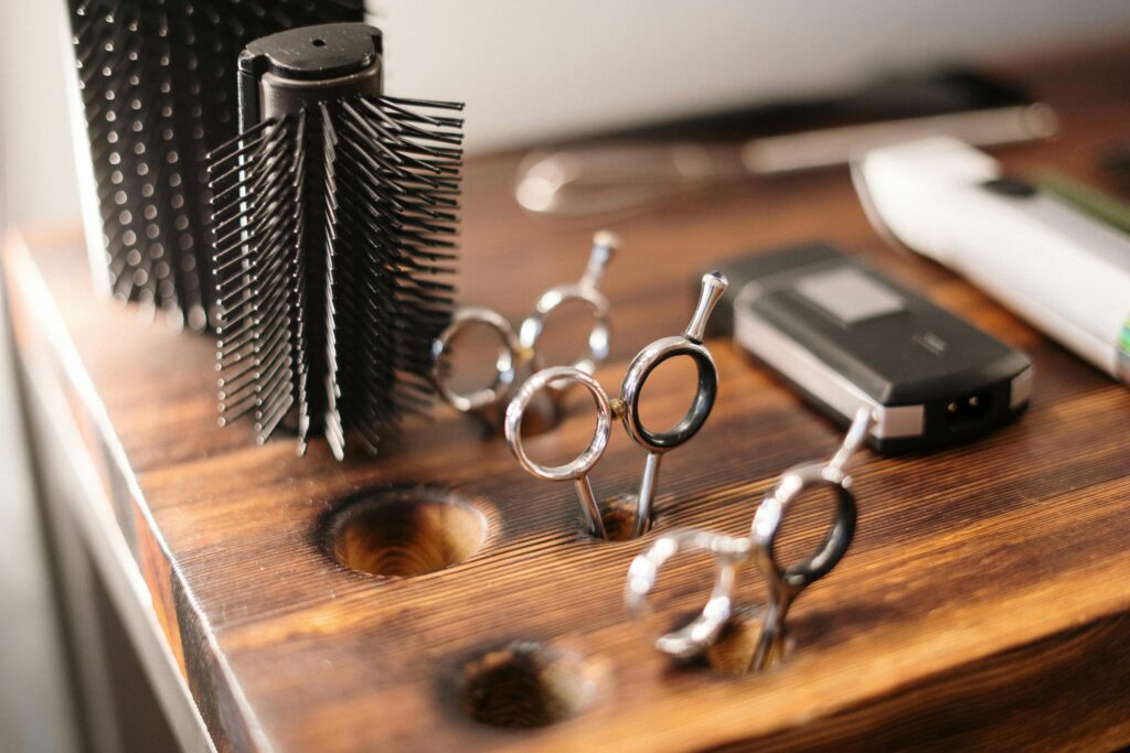 Close-up of barber tools on a stylish wooden counter, perfect for a salon setting.